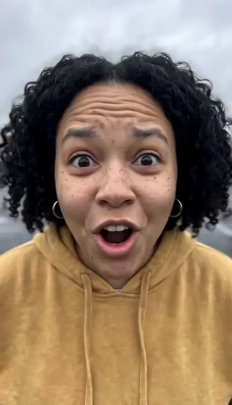 Sample video still: an AI-generated woman in the How I Become A Millionaire effect